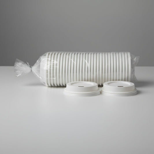 Fifty degradable sugarcane pulp cup lids packaged in PE bags with wire-tied closures are placed on the table, with two identical product lids positioned in front of them
