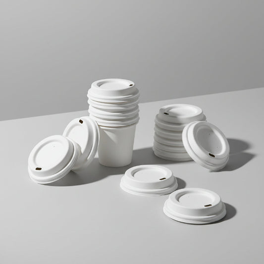Display of sustainable sugarcane-based cup lids for coffee shops, showing their natural fiber texture and circular design