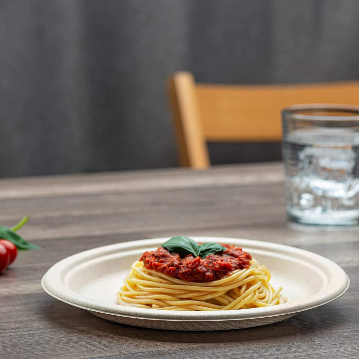 a white bagasse round plate with food on a table