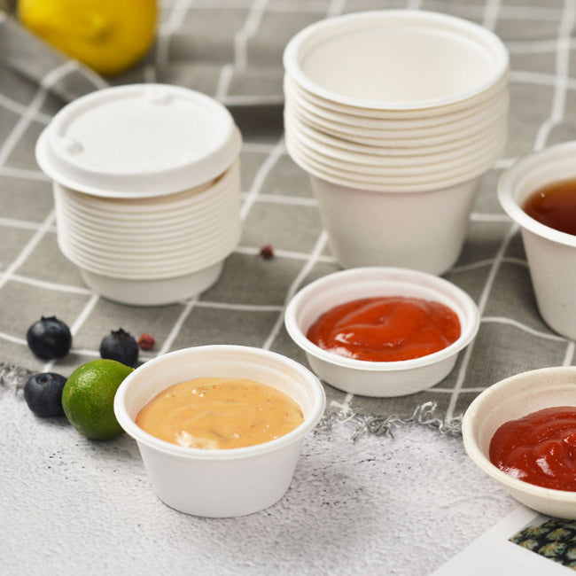 Different sizes of bagasse sauce cups on the table